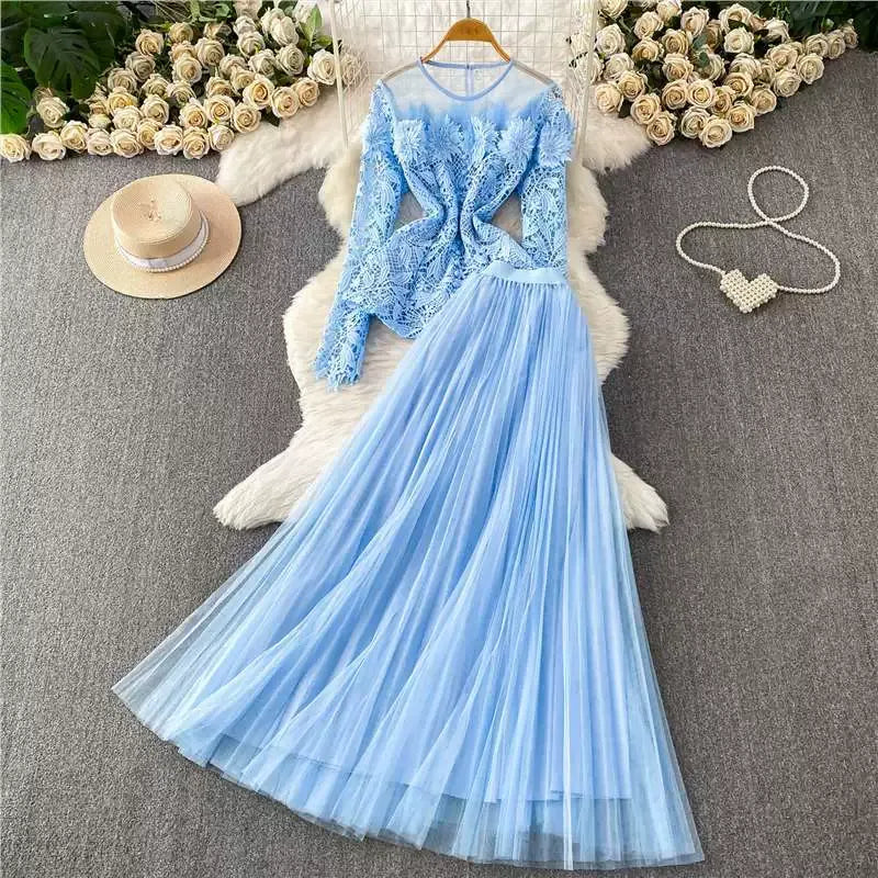 A luxurious, flowing, fairy-like long tulle dress with a sophisticated openwork lace design and a round neck, long sleeves, and a fitted waist. Two-piece set.