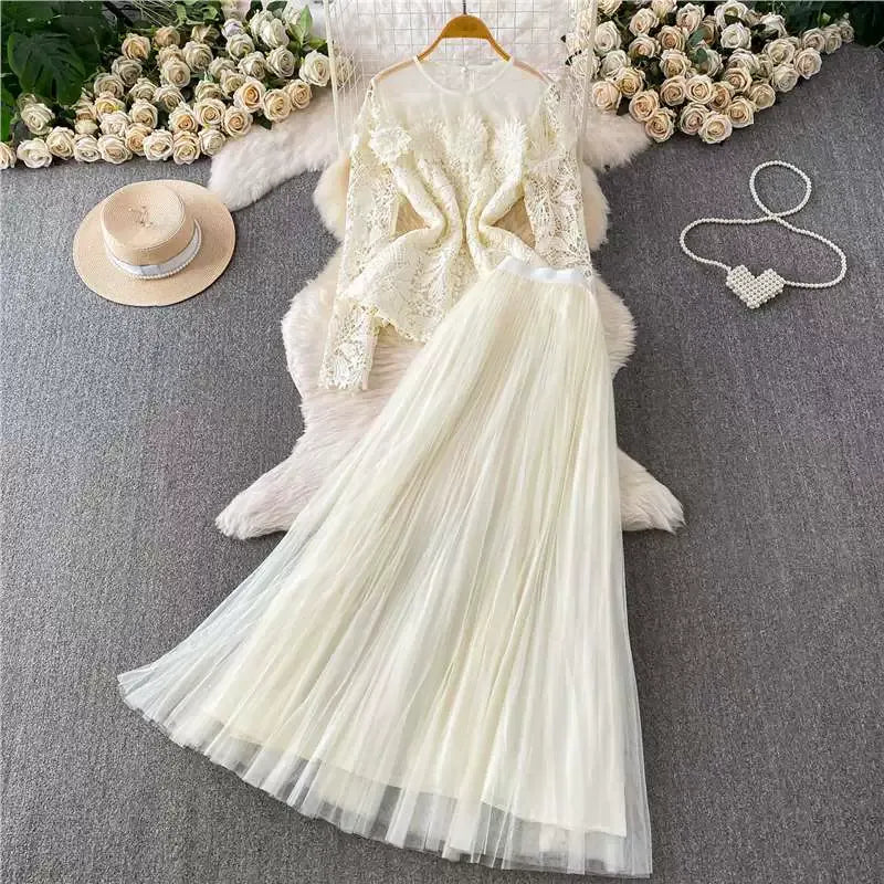 A luxurious, flowing, fairy-like long tulle dress with a sophisticated openwork lace design and a round neck, long sleeves, and a fitted waist. Two-piece set.
