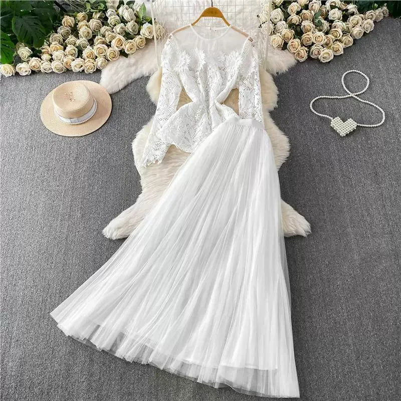 A luxurious, flowing, fairy-like long tulle dress with a sophisticated openwork lace design and a round neck, long sleeves, and a fitted waist. Two-piece set.