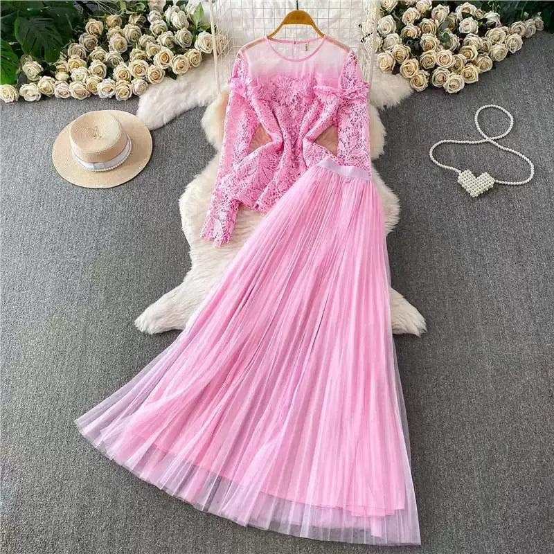 A luxurious, flowing, fairy-like long tulle dress with a sophisticated openwork lace design and a round neck, long sleeves, and a fitted waist. Two-piece set.